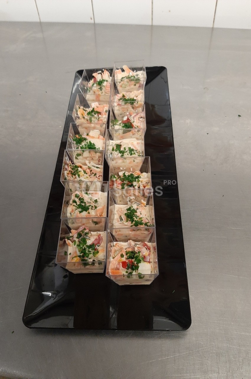Plateau de verrines garnies d'une préparation colorée à base de légumes et herbes fraîches, disposées sur une table en inox.