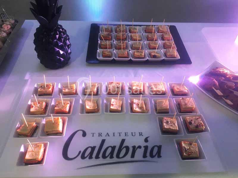 Plateau de verrines apéritives disposées sur une table avec une décoration en forme d'ananas noir.