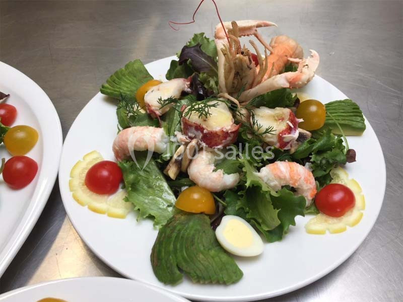 Assiette de salade composée avec crevettes, avocat, tomates cerises, œuf dur et herbes fraîches.