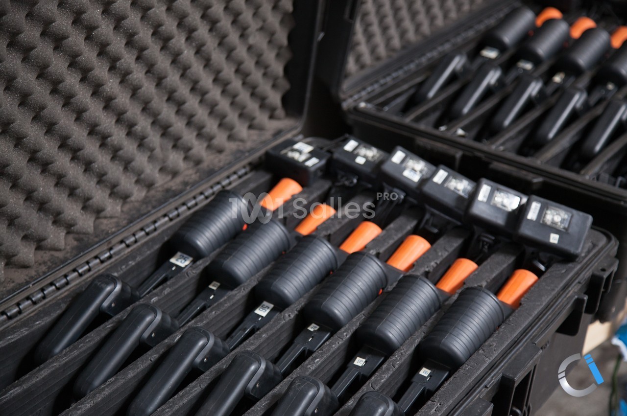 Valises ouvertes contenant plusieurs outils noirs avec poignées orange, rangés dans des compartiments en mousse.