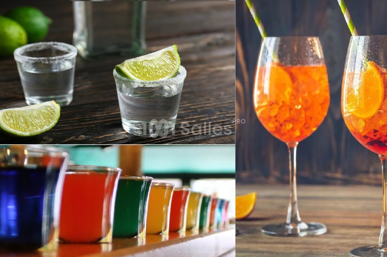 Verres de cocktails variés, dont des shots avec citrons verts et des spritz orange, posés sur des tables en bois.