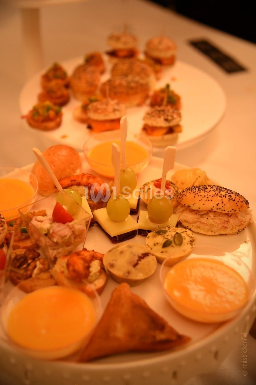 Plateaux de bouchées apéritives variées comprenant mini-burgers, verrines, brochettes et pâtisseries salées.
