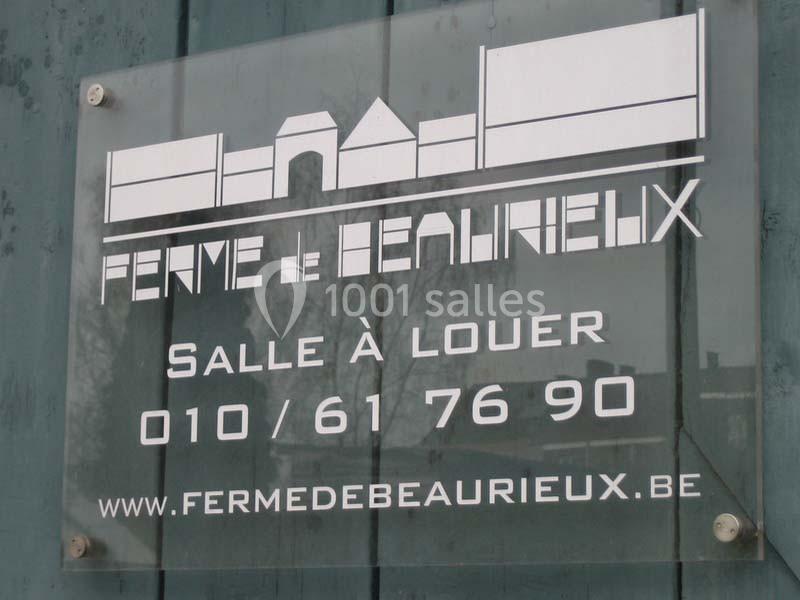Panneau en plexiglas indiquant ’Ferme de Beaurieux’, avec contact pour location de salle et site web.