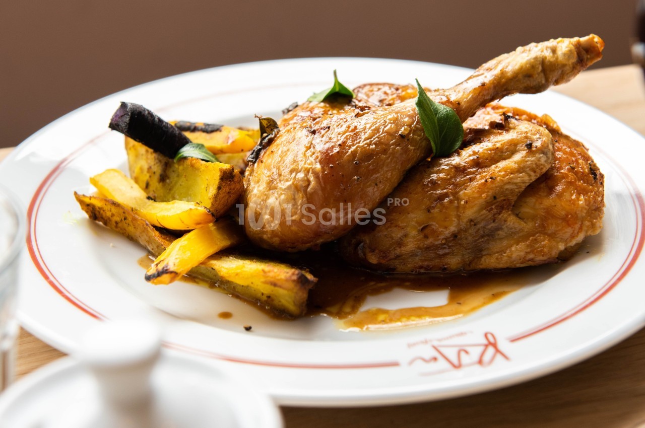 Plat de poulet rôti accompagné de légumes grillés, servi sur une assiette blanche.