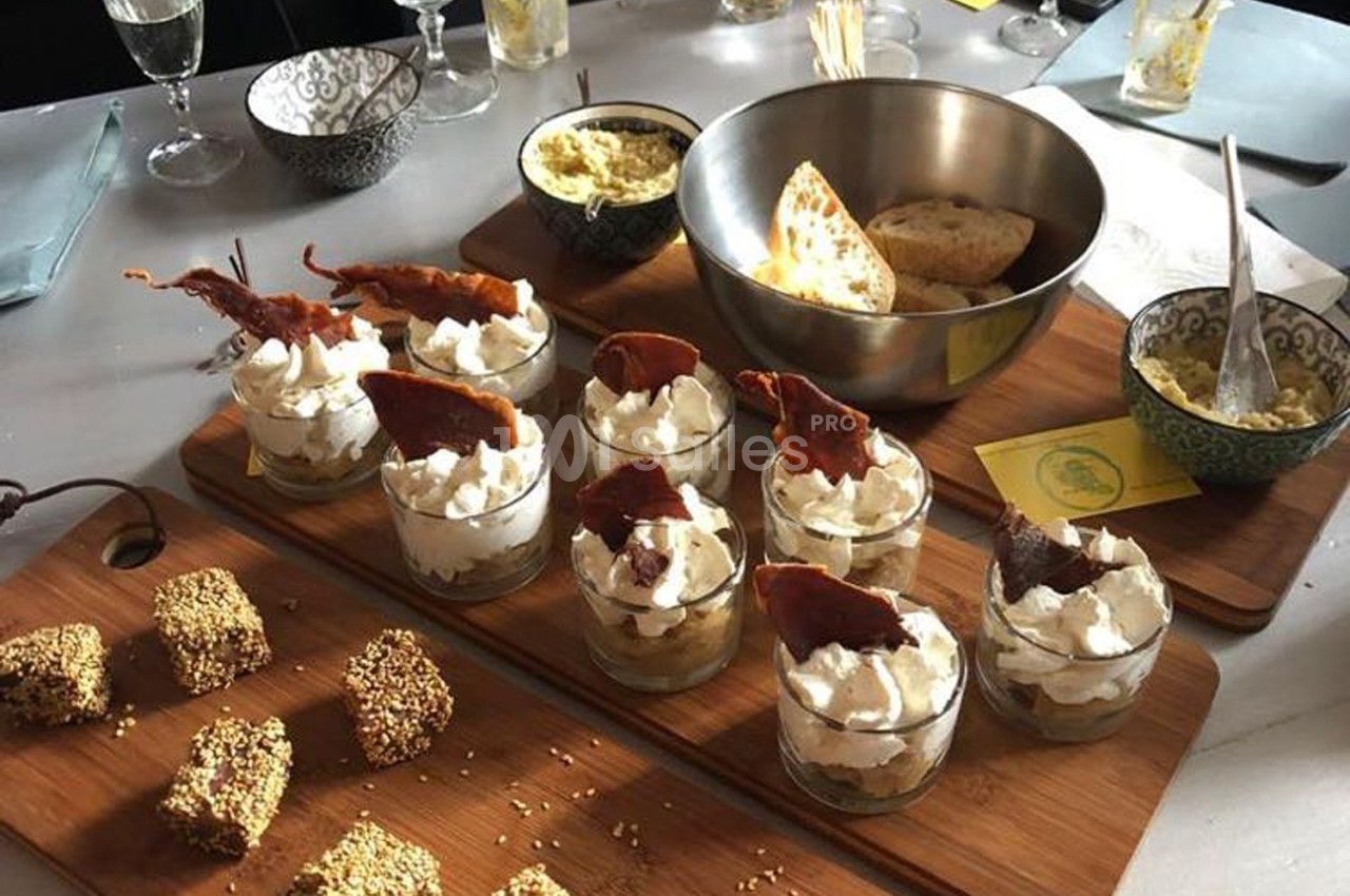 Plateau de verrines garnies de mousse et de chips croustillantes, accompagné de pain, dips et amuse-bouches au sésame.