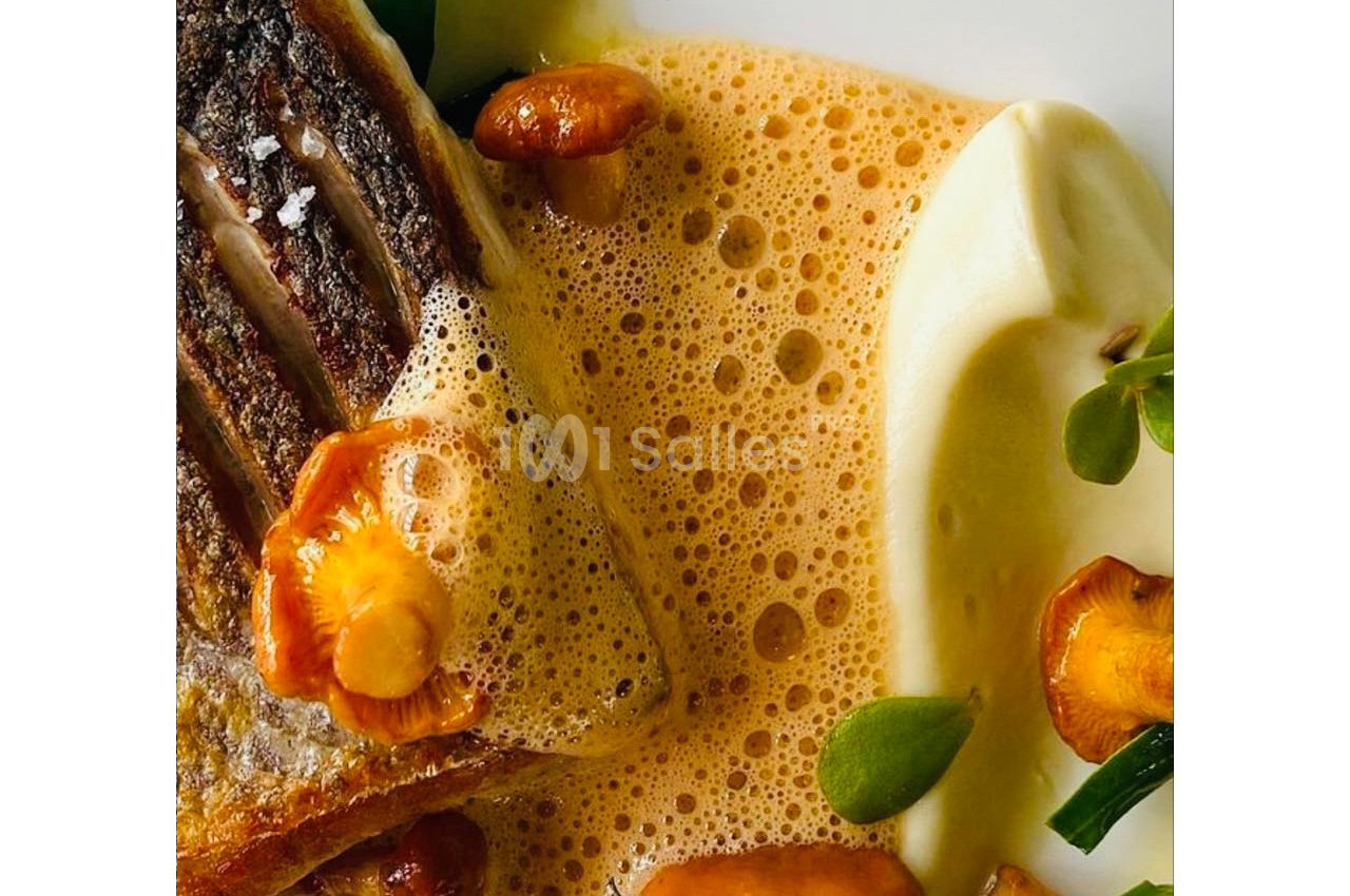 Filet de poisson grillé avec chanterelles, purée onctueuse et sauce mousseuse, décoré de jeunes pousses.