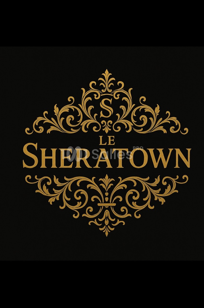 Motif décoratif doré avec le texte ’Le Sheratown’ et une lettre ’S’ stylisée, sur fond noir.