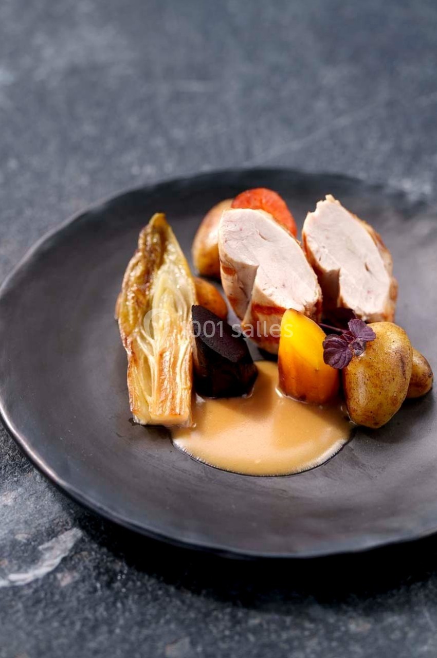 Assiette gastronomique avec filet de volaille, légumes racines, pommes de terre, endive braisée et sauce.
